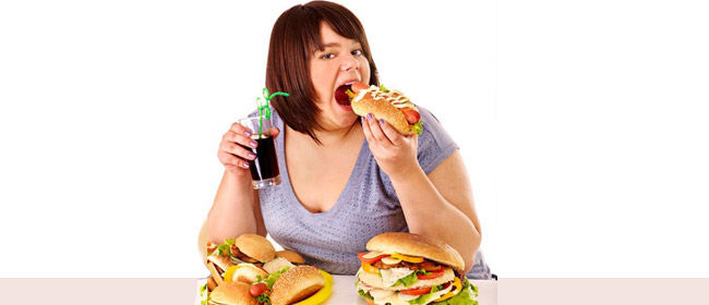 an obese woman eating junk food
