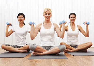 women doing yoga with weights